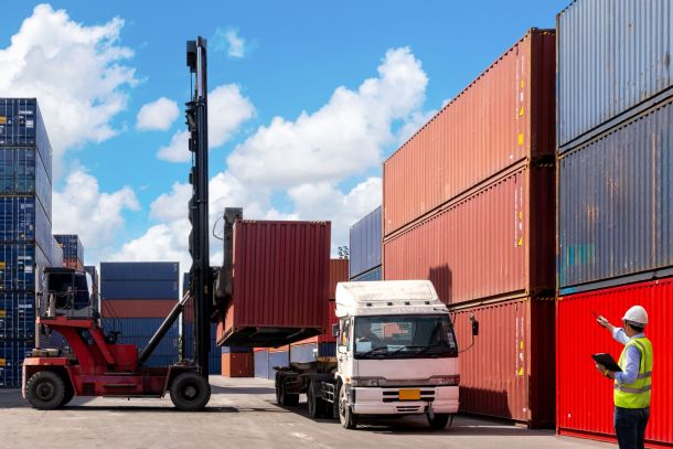 A foreman organising containers from a cargo ship.