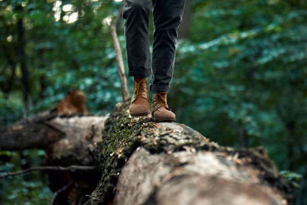 A man walking on a log.
