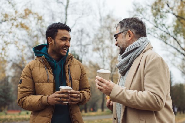 Two men talking together outdoors.