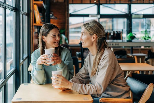 Two women talking in a coffee shop.