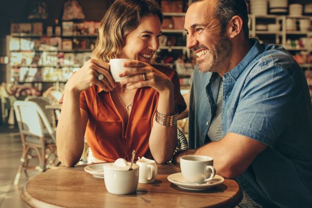 A couple laughing in a café.