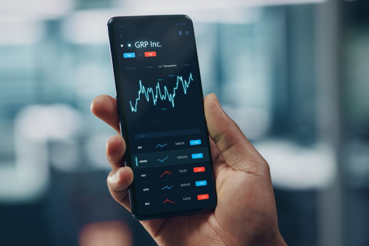 A man looking at stock market performance on his phone.