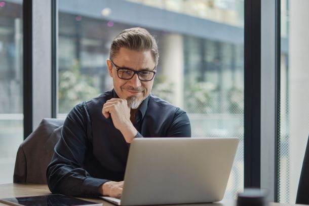 A man working on a laptop.