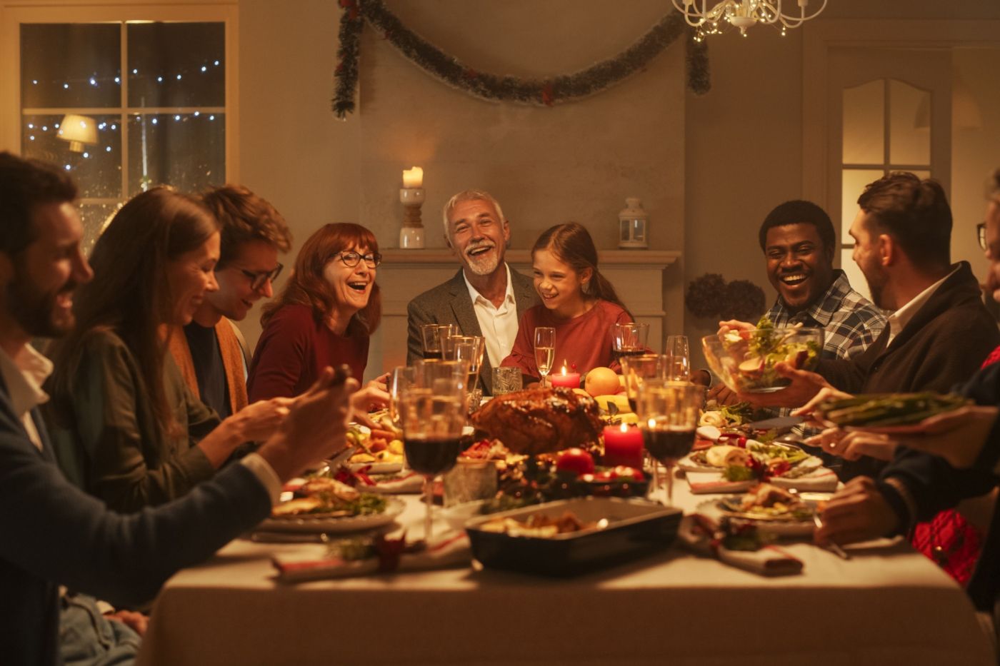 A multi-generational family gathered around a Christmas dinner table.